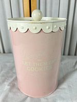 Front view of pink cookie tin showing text and overall shape