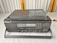 Front angle showing full radio, antenna, tilt stand, speaker grille and controls