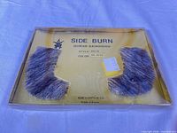 front view of sealed blister card showing both sideburn pieces and printed details