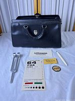 Bag with accessories laid out front view