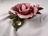 Full view of porcelain rose figurine showing bloom, leaves, Teleflora sticker