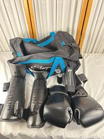 Overall lot with Evergreen duffel, Venum gloves and shin guards, Gymreapers straps