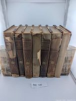 Front view of seven books between onyx bookends, visible spine wear