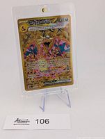 Front view of Charizard ex gold full art card in case