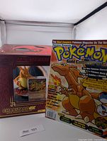 Boxed Charizard EX figure and magazine front cover