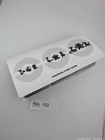 Closed white binder with Pokémon silhouettes