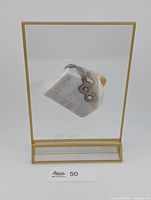 Full view of amethyst slice suspended in acrylic frame