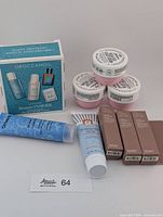 Group shot showing all items: Moroccanoil kit, 4 Sol de Janeiro tubs, Clinique tube, First Aid Beauty tube, 3 Rare Beauty boxes