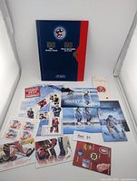 Overall lot layout with presentation folder and multiple stamp products