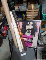 Group shot showing Frank Zappa poster and six rolled posters