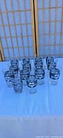 Group view of all 14 Modelo pint glasses on table