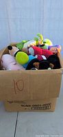 Full view of cardboard box filled with plush toys