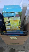 Cardboard box containing beverage dispenser box, chair bag, misc. items