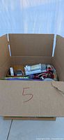 Overall view of cardboard box with contents visible