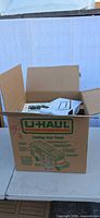 U-Haul box holding assorted packaged items