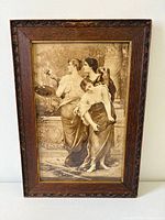 Full view of sepia print with three women in carved oak frame