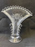 Front view showing cornflower etching, ruffled rim, bubble prunts and foot