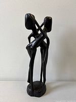 Front view of ebony wood abstract lovers sculpture