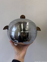 Full view of server showing penguin motif, wood handles and knob