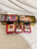 Overall view of two metal tins and stacks of red-border MetaZoo cards