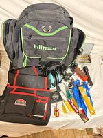 Contents overview: Hilmor backpack, Jobmate pouch, earmuffs, screwdrivers, drill bits, flashlights, gloves, scraper