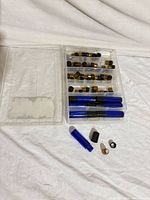 Open storage case showing blue roller bottles, amber vials, and empty left compartment