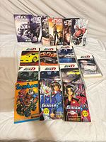 All 16 manga volumes laid out on white background