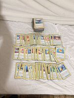 Stack and spread of sleeved Pokémon trainer and item cards