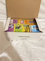Open box showing stacks of Pokémon cards