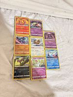 Nine sample Pokémon cards laid out in three-by-three grid showing set variety and condition