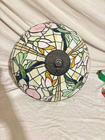 Full view of stained glass shade showing floral pattern and metal cap