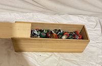 Wooden box open with assorted bottle caps inside