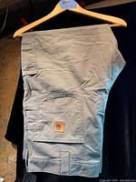 Full view of pants hanging to show front and utility pocket