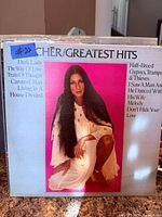 Front cover of Cher Greatest Hits LP showing artist photo and song list