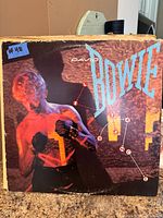 Front cover of David Bowie "Let's Dance" LP showing artwork and wear