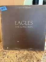 Front view of Eagles The Long Run album cover showing wear