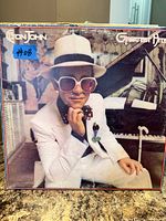 Front cover of Elton John Greatest Hits LP displaying artist photo and title
