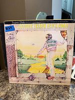 Front cover of Elton John Goodbye Yellow Brick Road Super Disk edition LP displayed upright