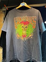 Full front view of black Guns N' Roses T-shirt on hanger