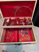 Open jewelry box showing trays and assorted contents
