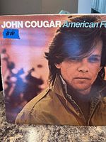 Front cover of John Cougar American Fool LP showing artist portrait and title text