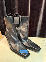 Full view of both boots standing, showing square toes and block heels