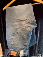 Jeans folded on hanger showing overall fabric and color