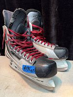 Side view of both Bauer skates showing size tag and laces