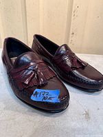 Pair of burgundy tassel loafers front and side view