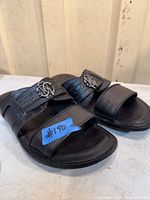 Full view of the pair showing straps, emblems, and overall condition