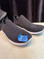 Side view of both shoes showing knit upper and midsole