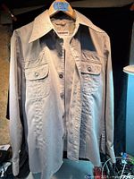 Front view of taupe McGregor long-sleeve work shirt hanging