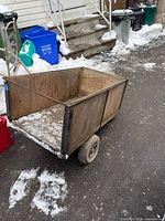Side view of wooden box trailer on metal frame with wheels