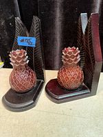 Both carved wood pineapple bookends front and side views